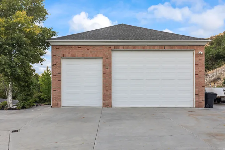 Garage featuring concrete driveway