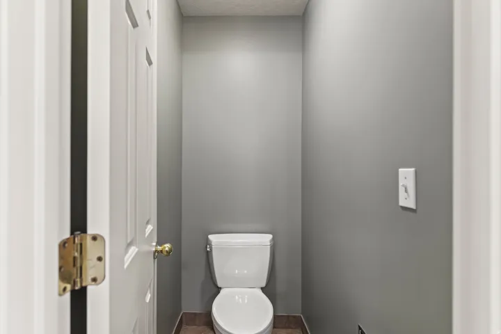 Bathroom with toilet and a textured ceiling