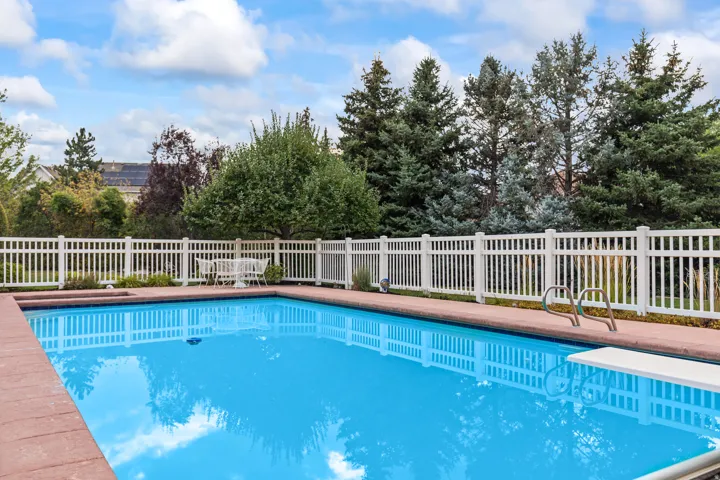 View of swimming pool with a diving board