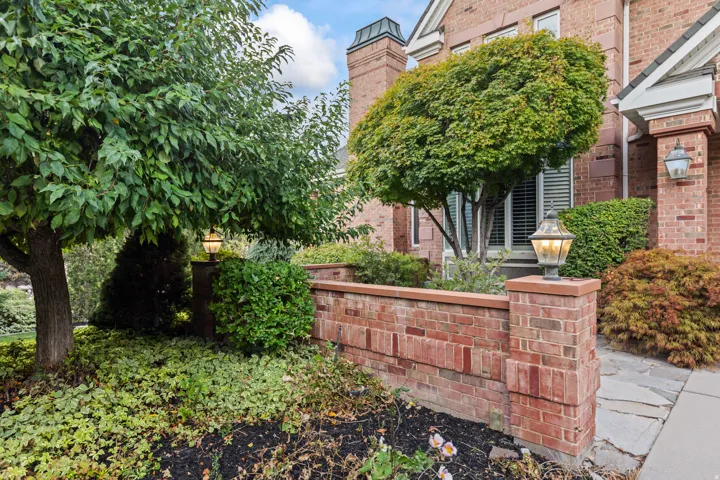 Exterior space featuring brick siding and a chimney