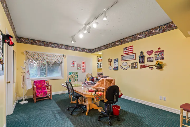 Office area featuring dark carpet and baseboards