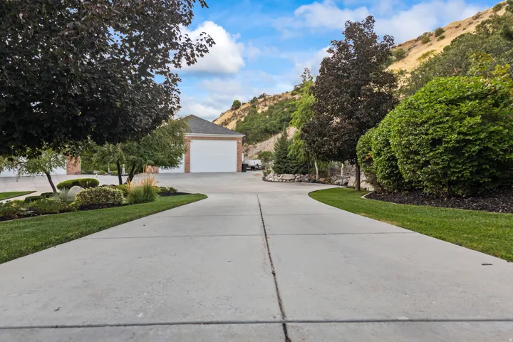 View of front of home with concrete driveway and a mountain view