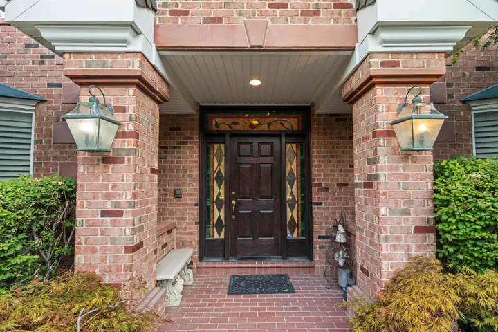 View of exterior entry featuring brick siding