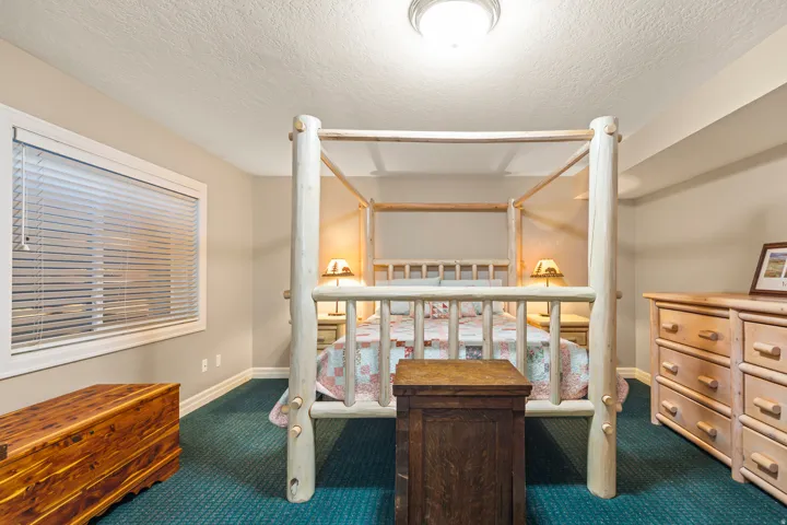 Carpeted bedroom featuring a textured ceiling
