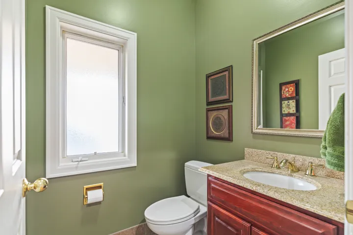 Half bath featuring toilet and vanity