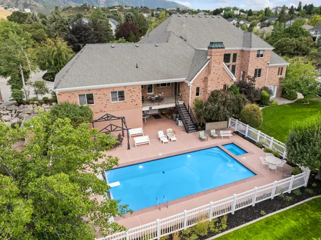 View of swimming pool with patio surround, a fenced backyard, and outdoor dining space