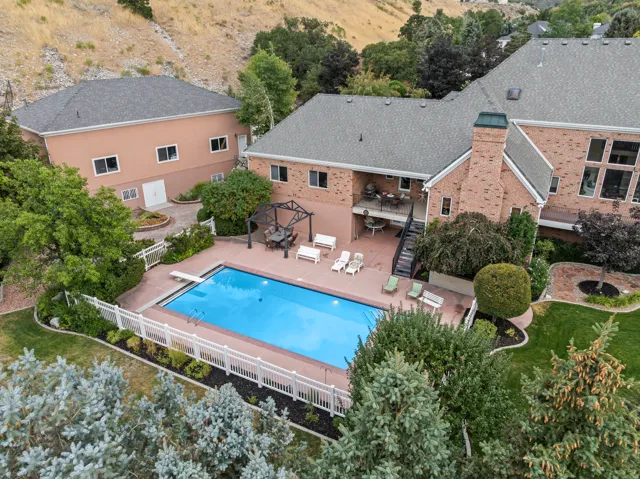 View of swimming pool with patio surround and a fenced backyard