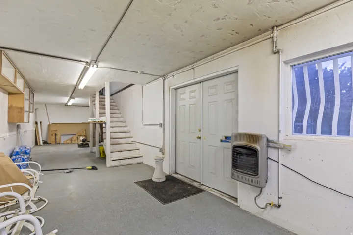 Basement with stairway and heating unit