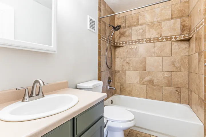 Bathroom featuring a tiled shower and bathtub combination