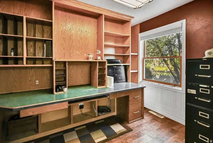 Built-in wood cabinetry and desk featuring ample shelving and storage