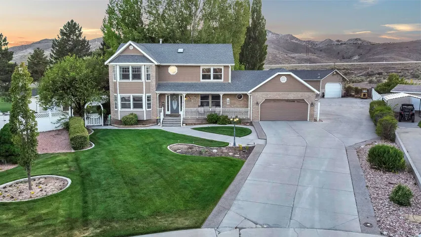 Two-story residence with a stone and siding exterior and an attached two-car garage