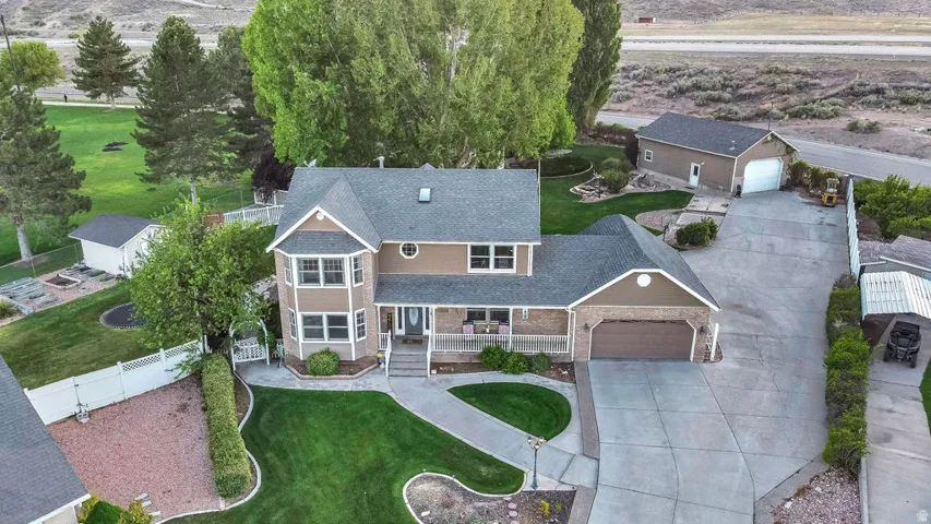 Two-story residence featuring a bay window, covered porch, and attached two-car garage