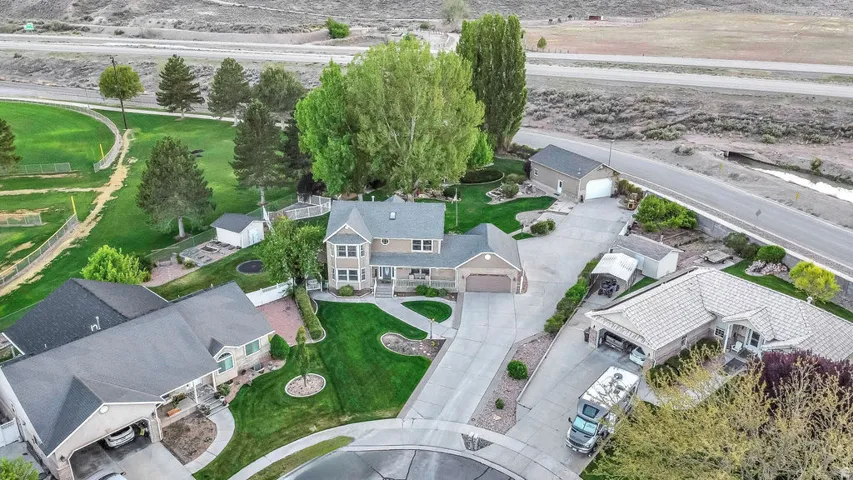 Two-story residence featuring a covered front porch, an attached garage, and a detached two-car garage