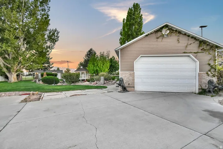Single-car garage with horizontal siding and brick accents