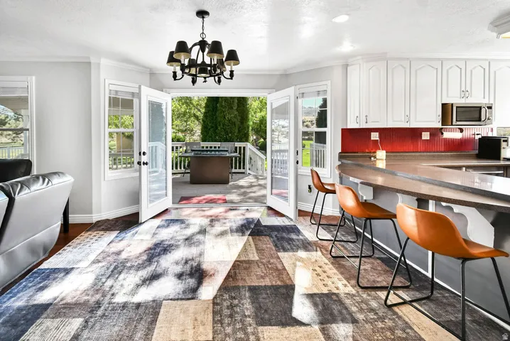 Open-concept living space featuring French doors leading to a spacious outdoor deck