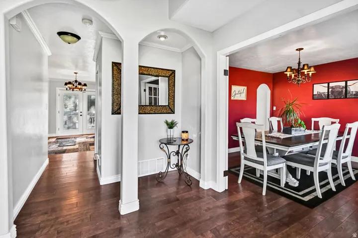 Formal dining area with rich red walls and a classic chandelier