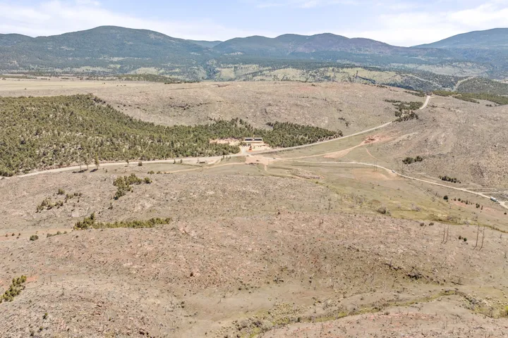 Expansive landscape featuring rolling hills and distant mountains