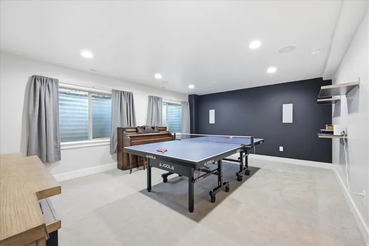 Spacious lower-level room featuring recessed lighting and light-colored carpeting