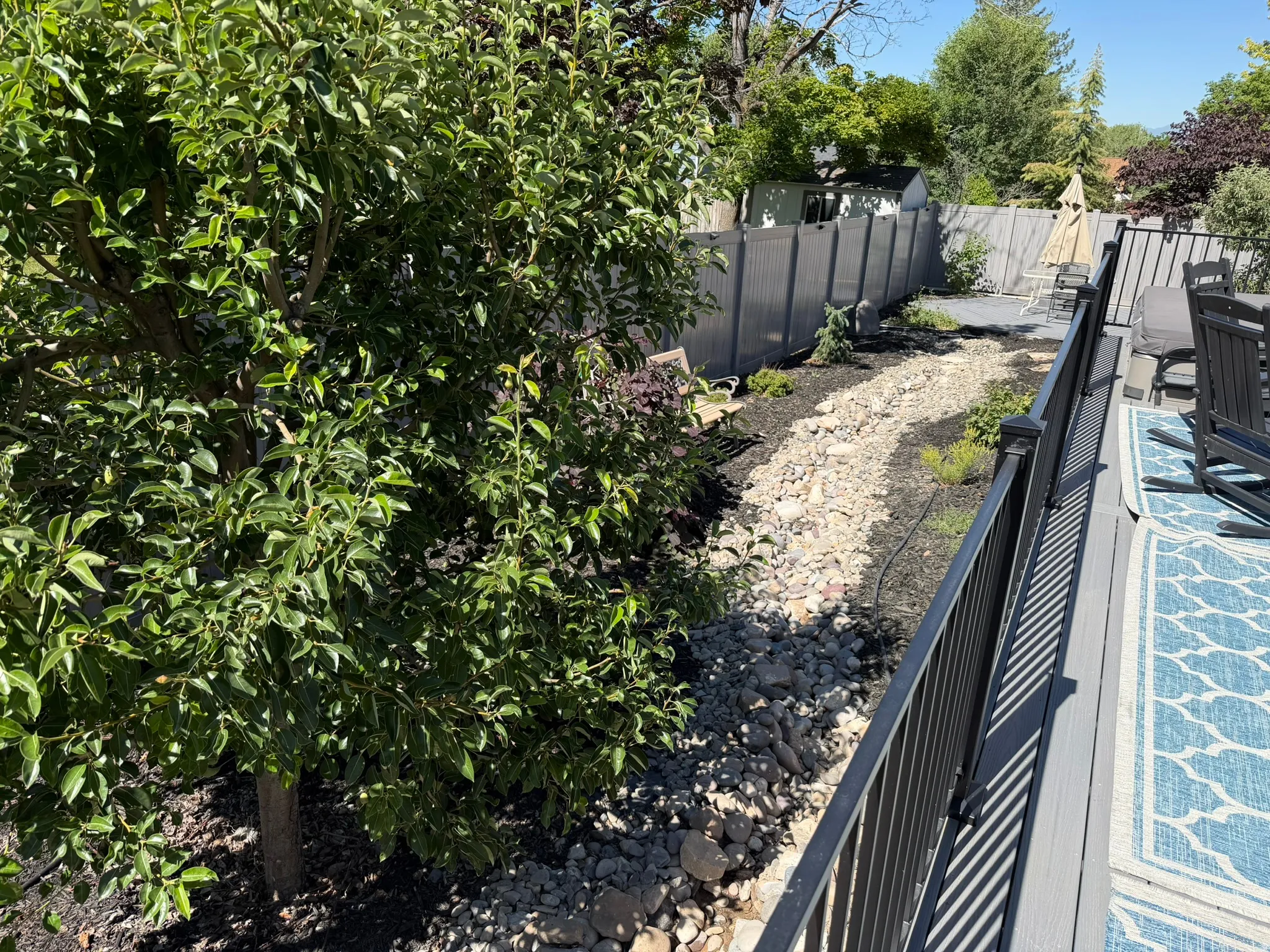 Outdoor deck featuring a composite surface and black metal railings