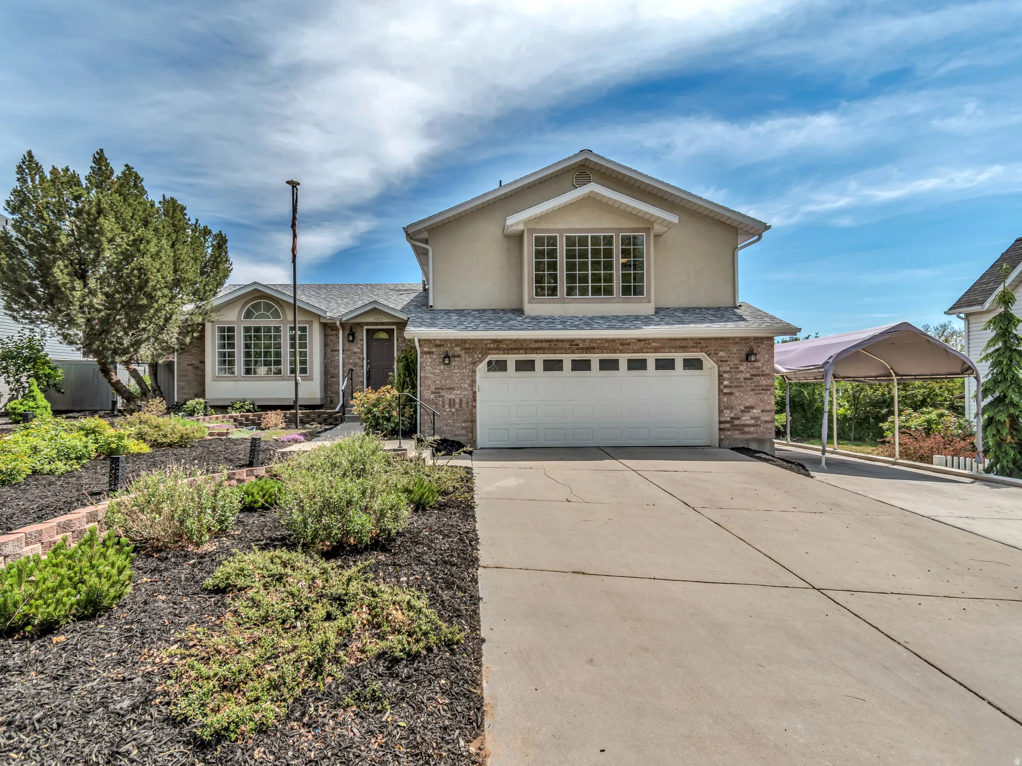 Two-story residence featuring brick and stucco siding