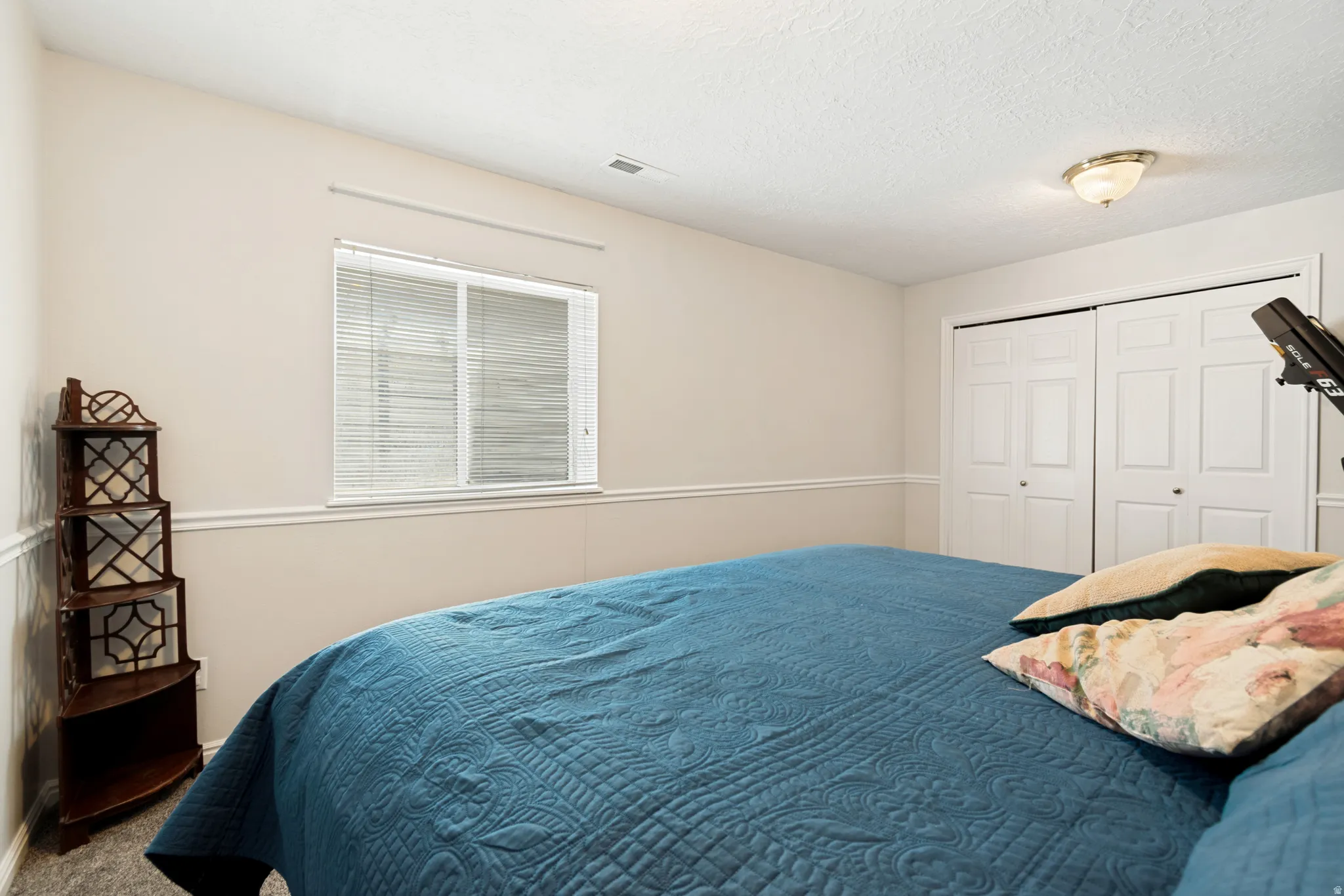 Interior room featuring carpeted flooring and neutral wall tones