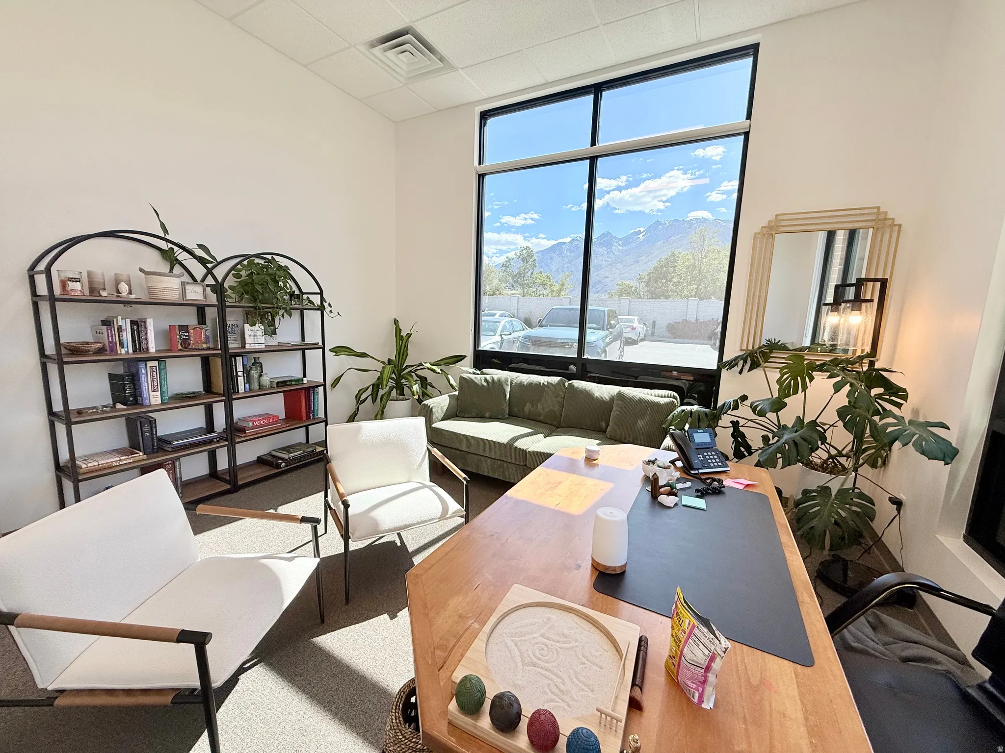 Room featuring extensive window frontage, a mountain backdrop, ceiling-mounted ventilation, and recessed ceiling lighting