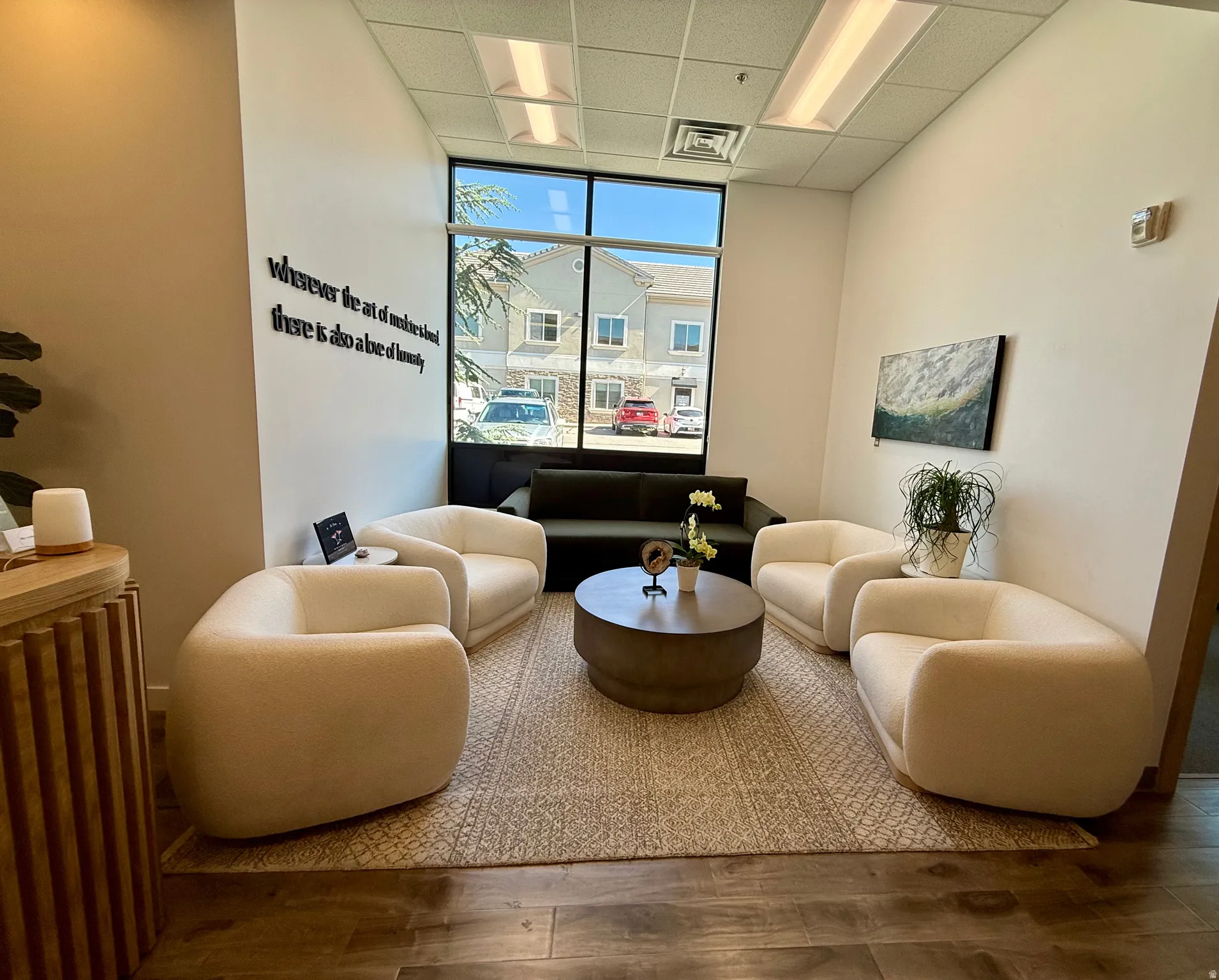 Spacious reception area with high ceilings and wood-finish flooring