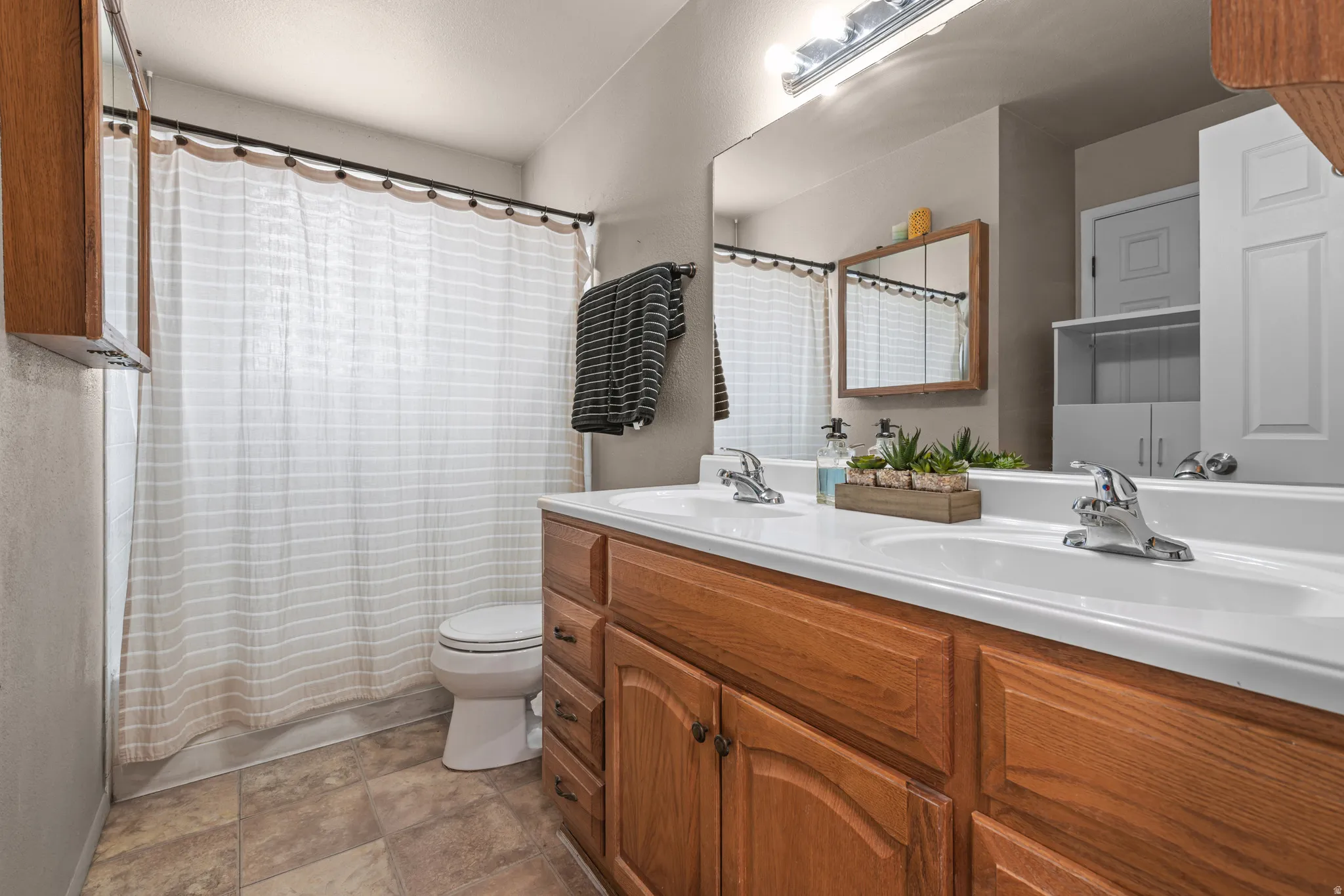 Double vanity with integrated sinks and chrome fixtures