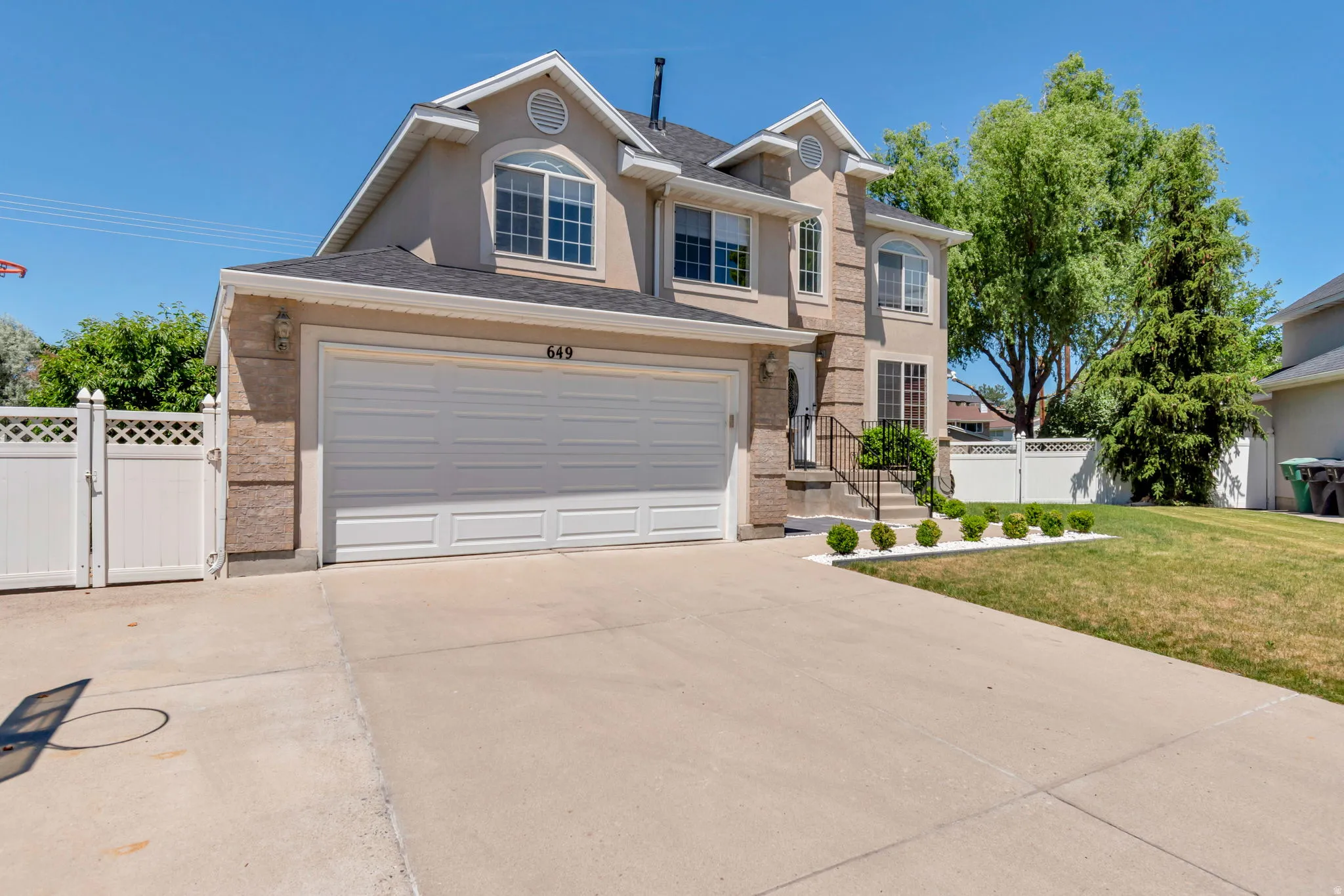 Stucco exterior with stone accents and a two-car garage