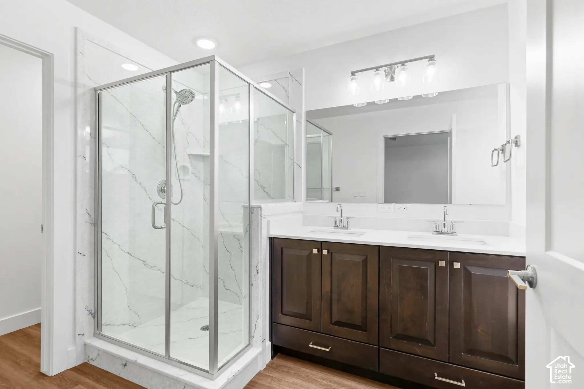 Glass-enclosed shower with a built-in bench