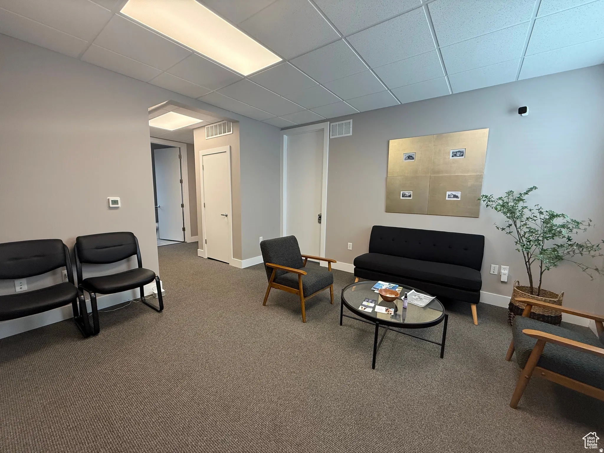 Carpeted waiting area featuring recessed lighting, light gray wall paint, and white trim