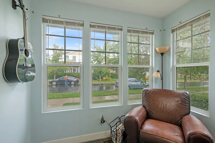 Corner room featuring multiple large windows with white frames, providing abundant natural light