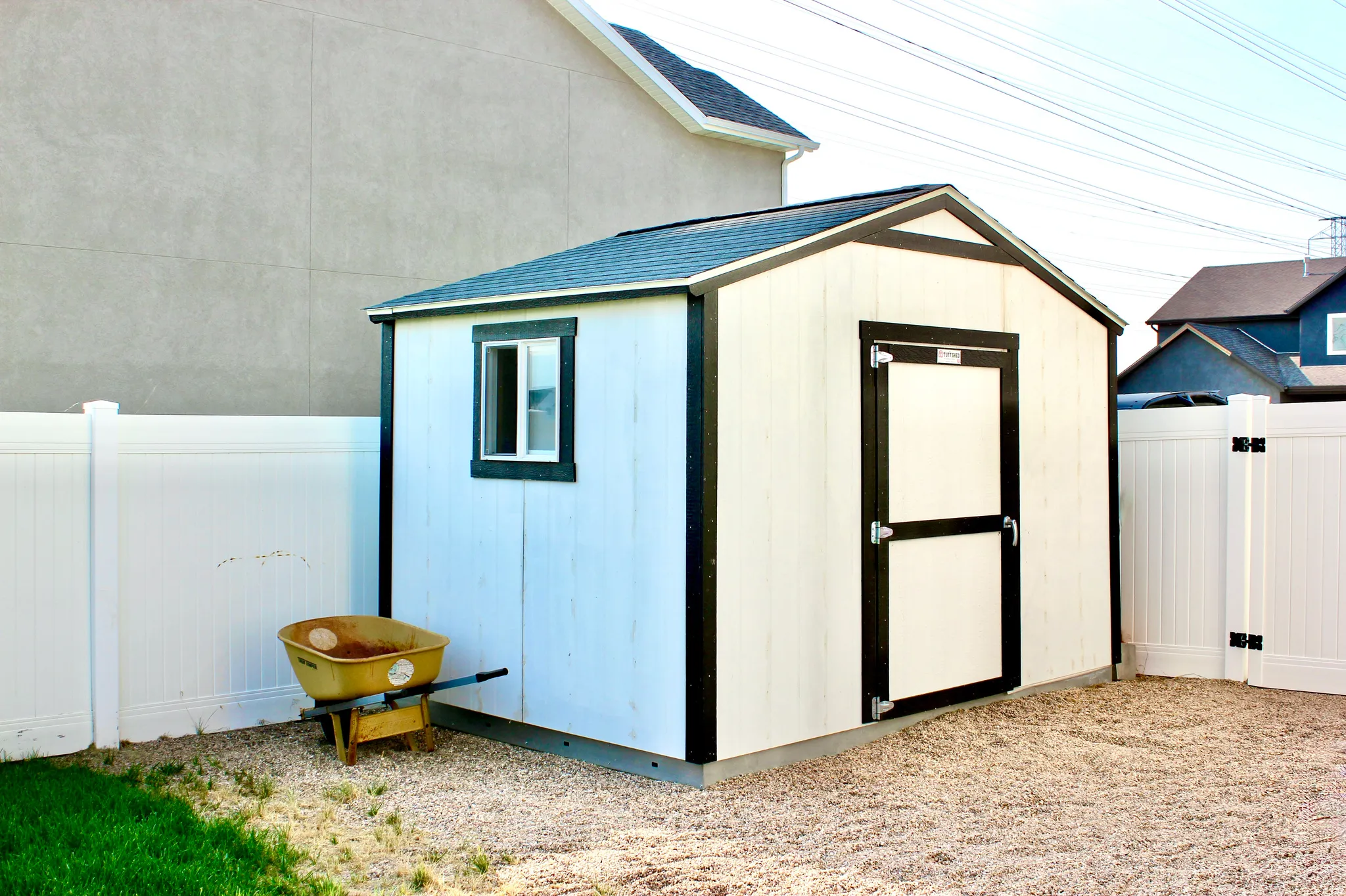 Storage shed featuring a gabled roof and exterior window