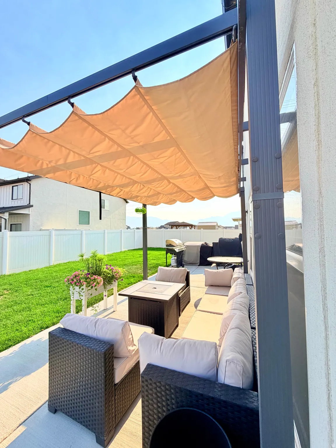 Paved patio with a retractable fabric pergola