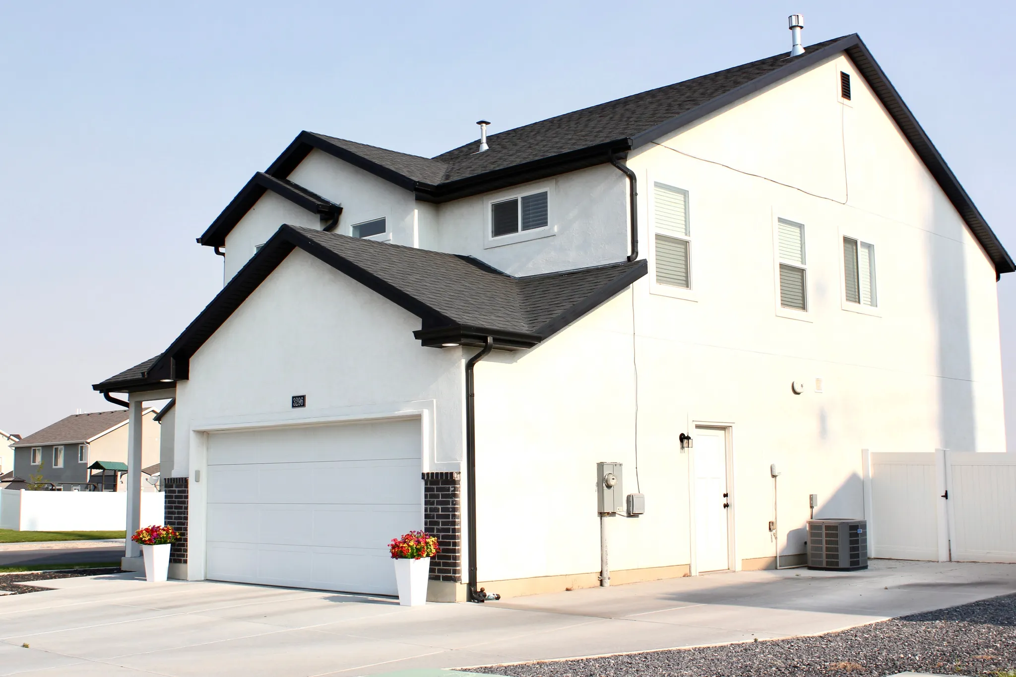 Contemporary exterior with white stucco finish and contrasting black roof