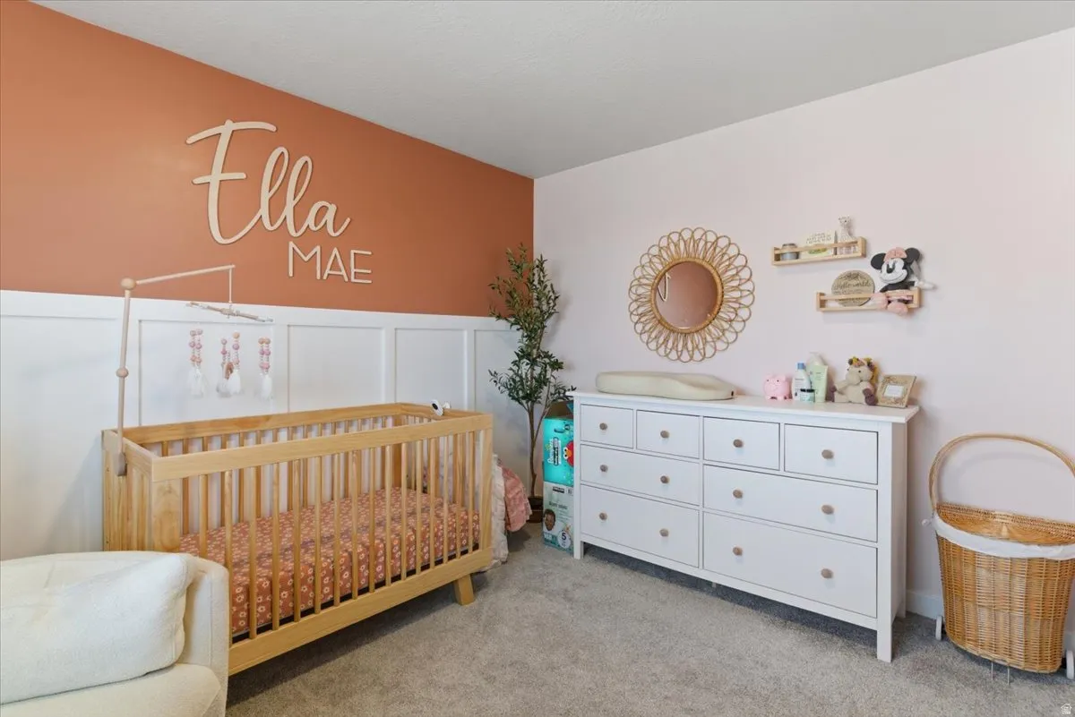 Room featuring wainscoting and two-tone wall paint