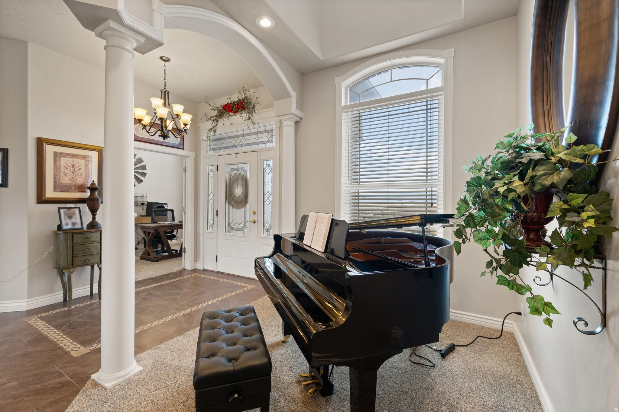 Grand entry featuring an elegant archway and a prominent white column