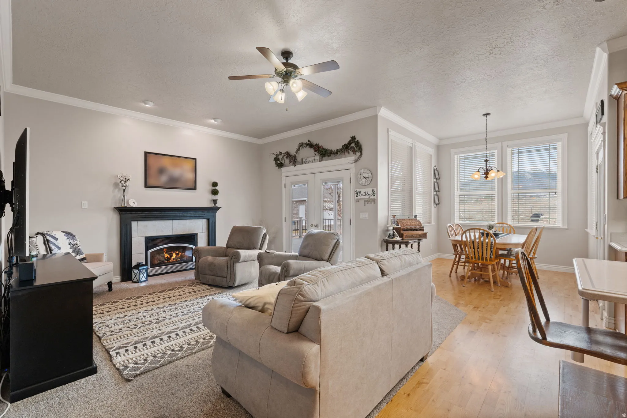 Living area featuring a fireplace with a dark mantel and light tile surround