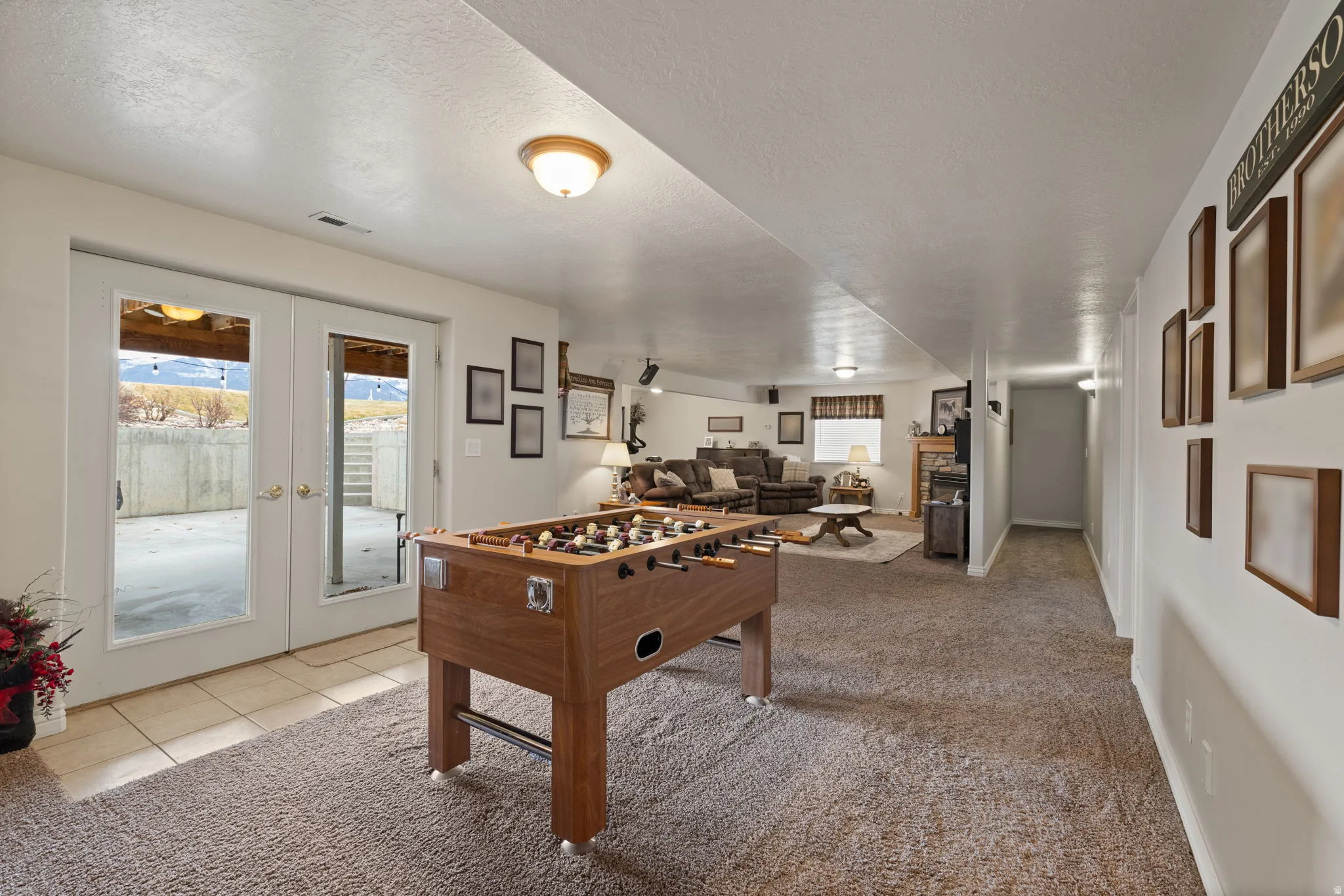 Spacious recreational area or flex space between basement kitchen and family room