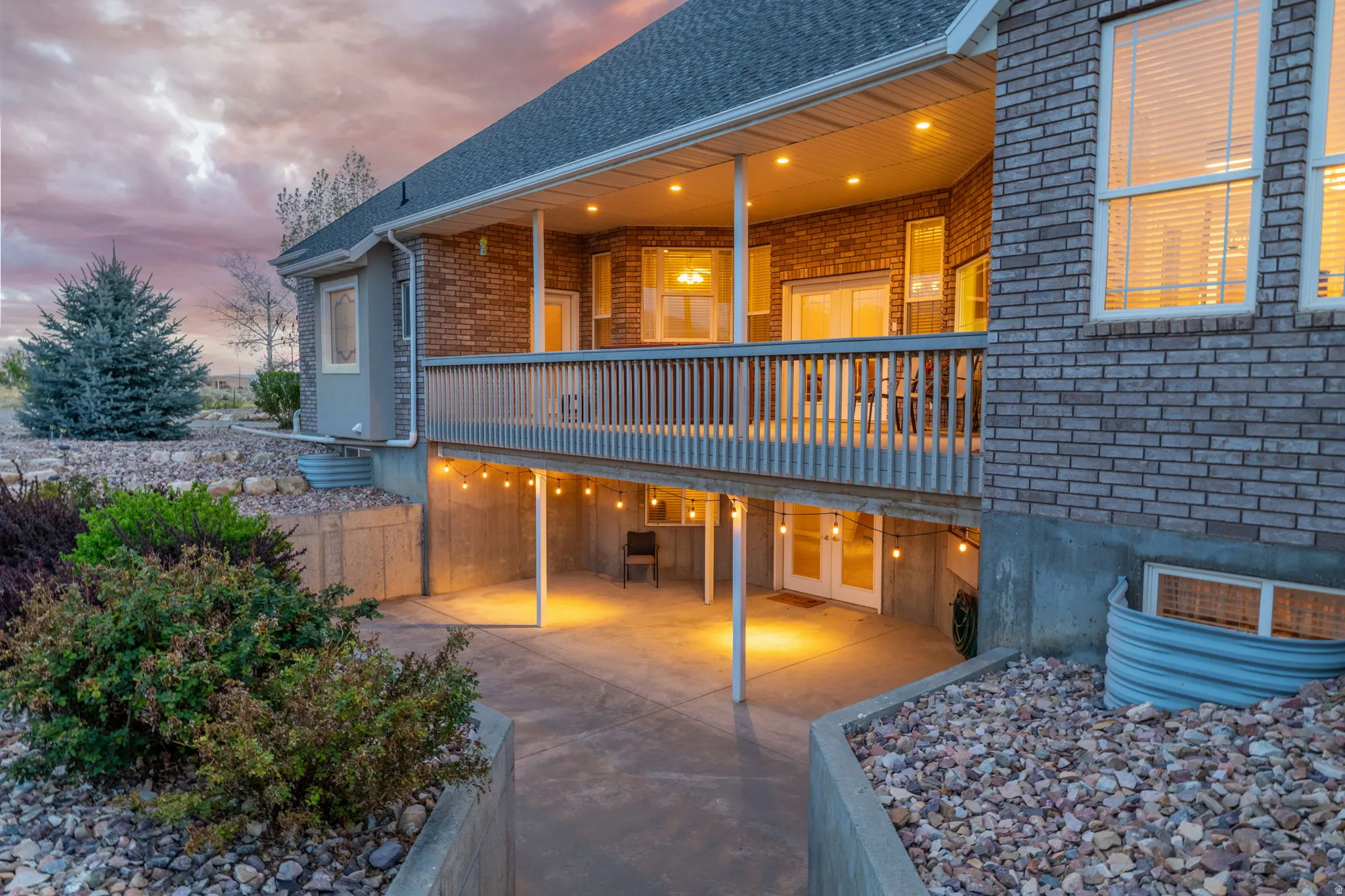 Brick exterior featuring a covered deck with recessed lighting, offering an outdoor living space