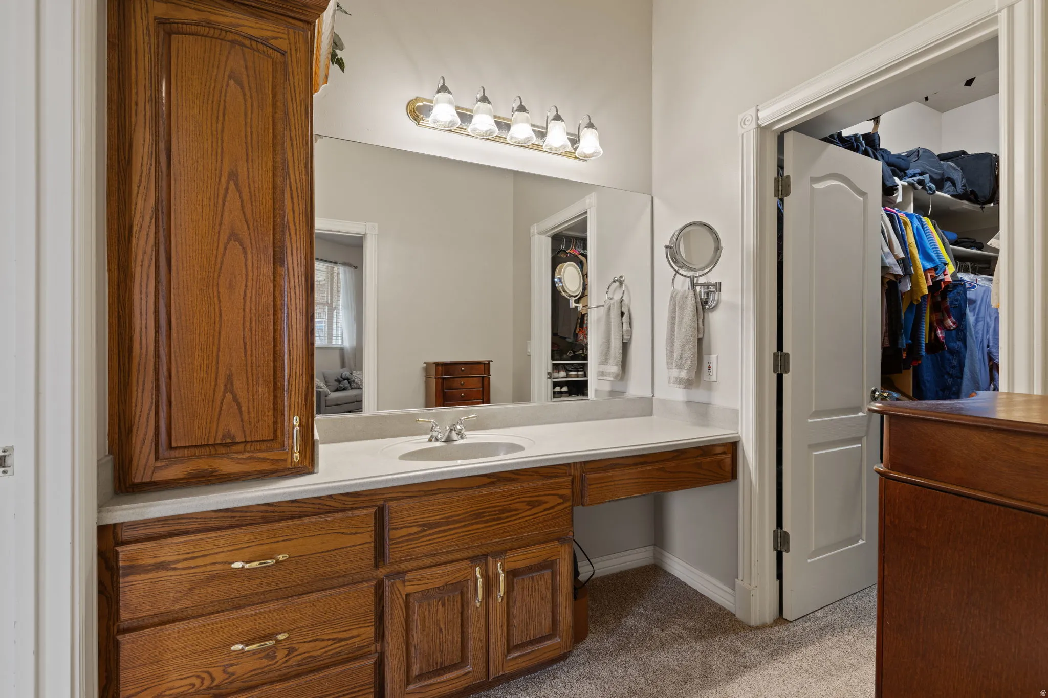 Primary en-suite with second vanity; private dressing and seated vanity