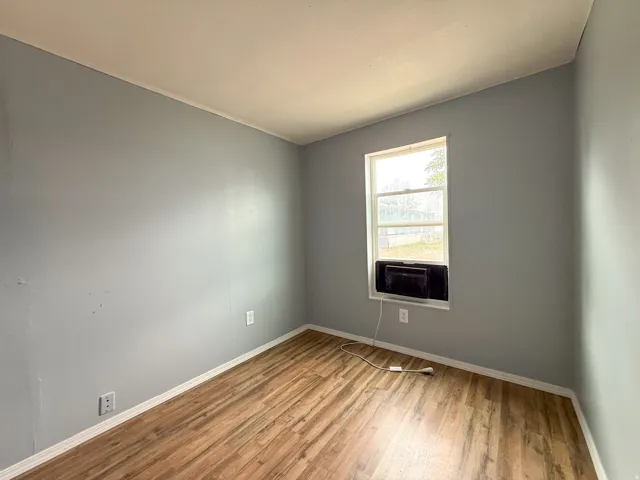 Interior space featuring wood-finish flooring and light gray walls