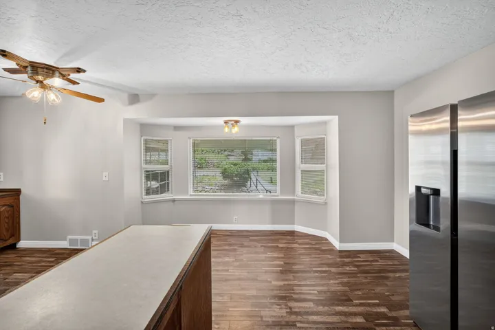 Bay window area featuring wood-finish flooring and a ceiling-mounted light fixture