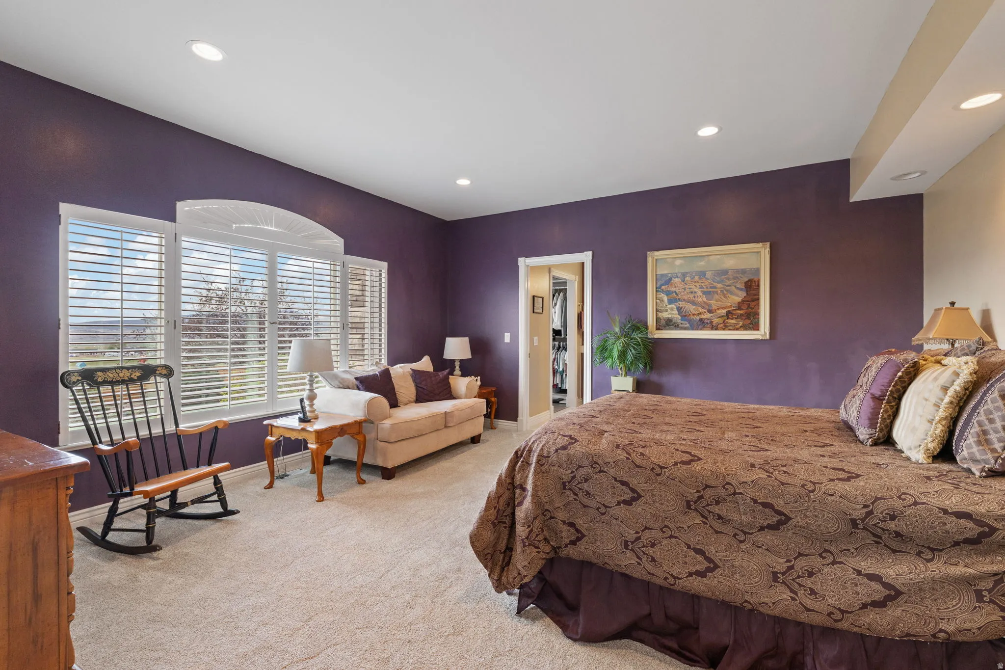 Spacious primary bedroom with oversized windows for ample natural lighting