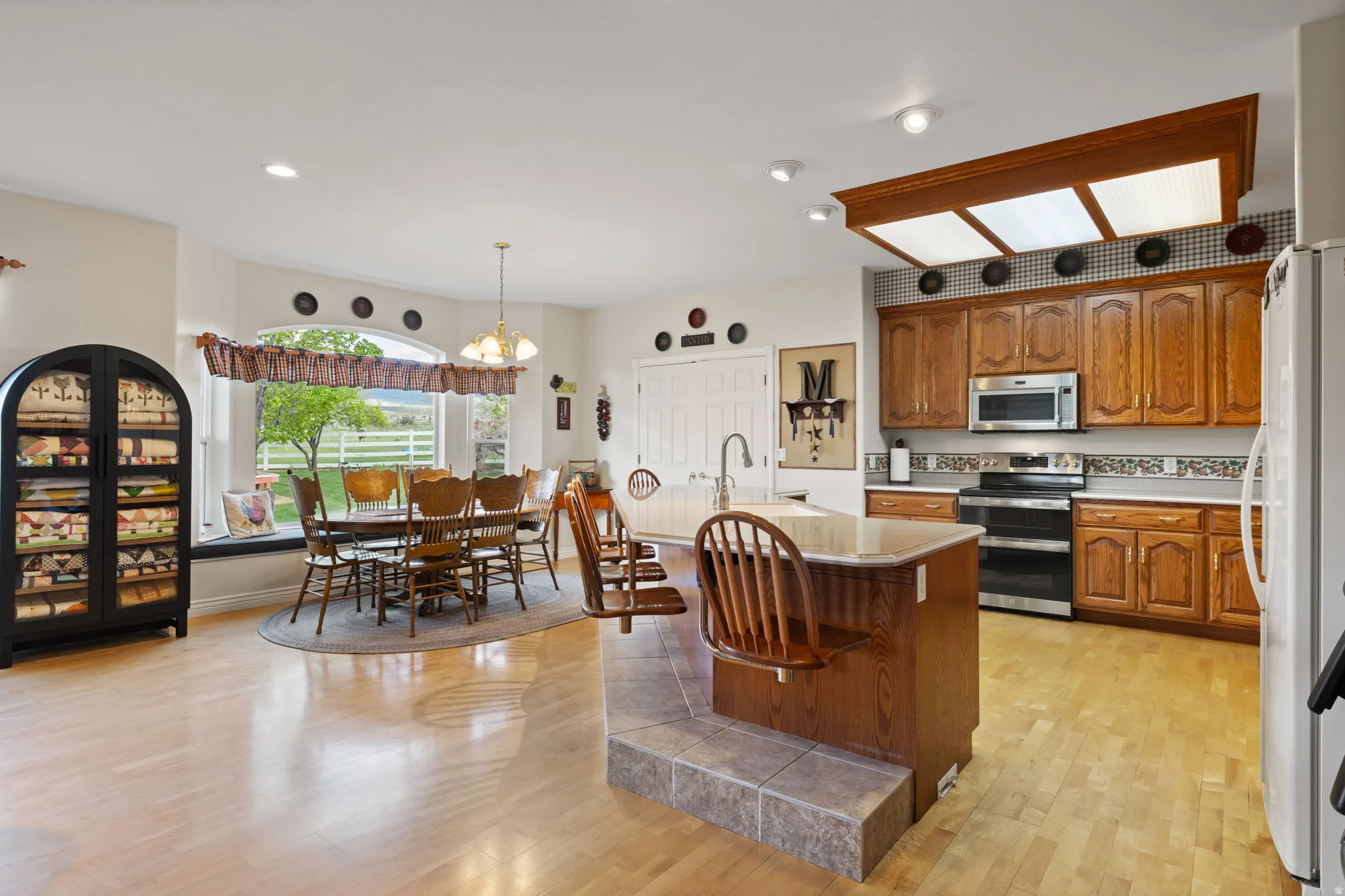 Open concept kitchen and dining area with wood-finish flooring