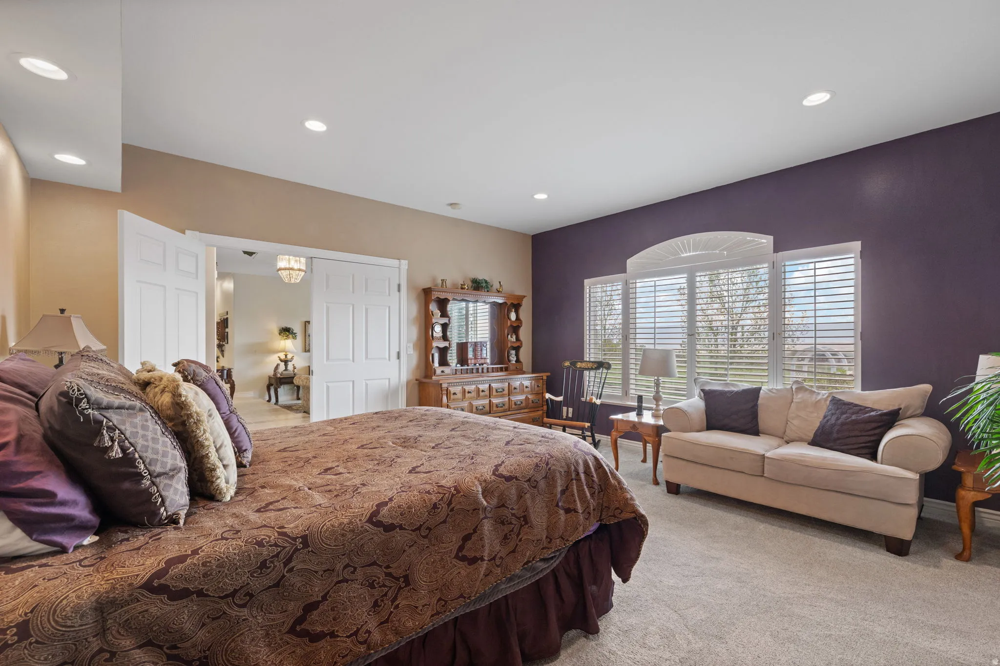Spacious primary bedroom with oversized windows for ample natural lighting