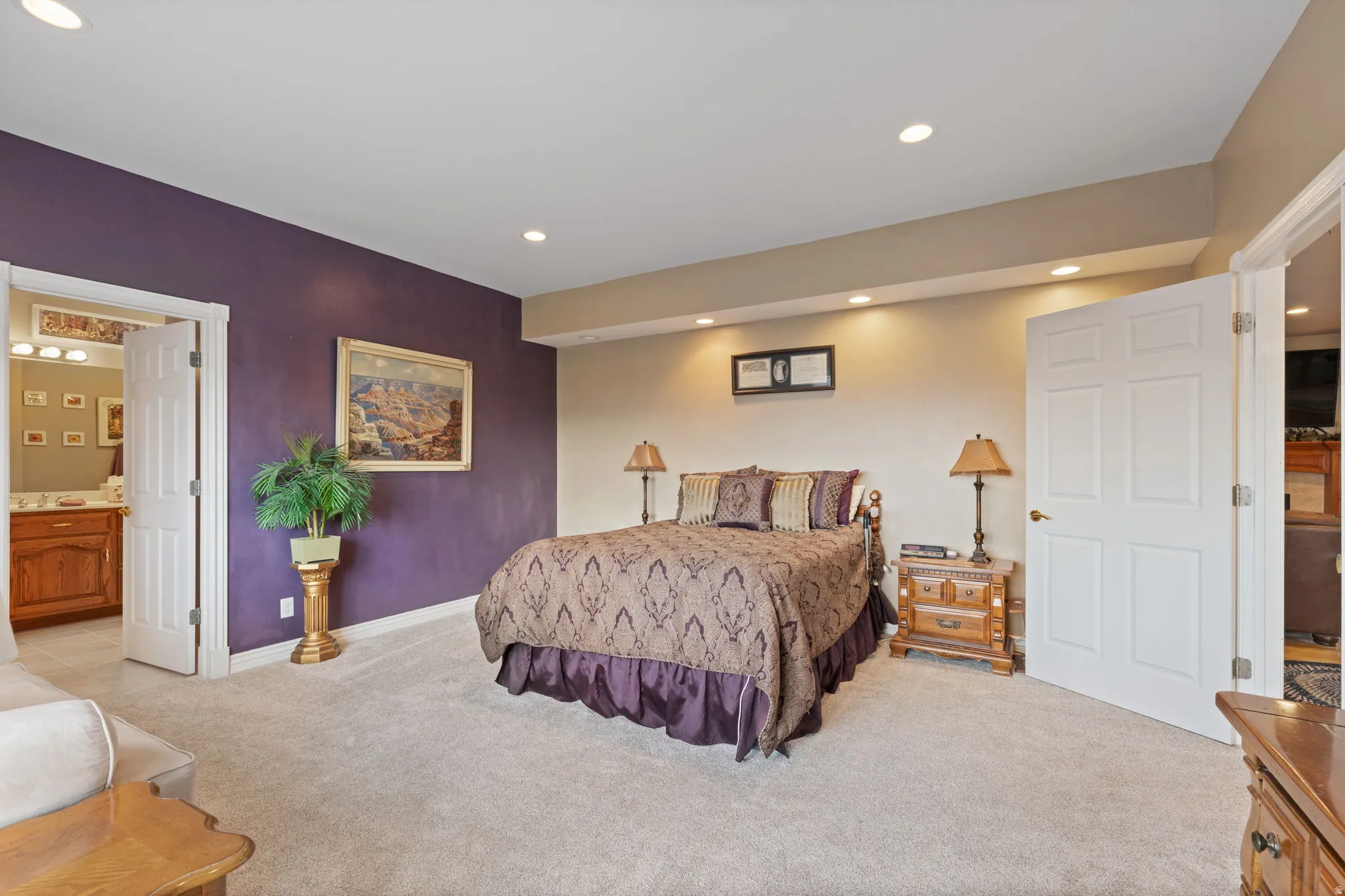 Spacious primary bedroom with oversized windows for ample natural lighting