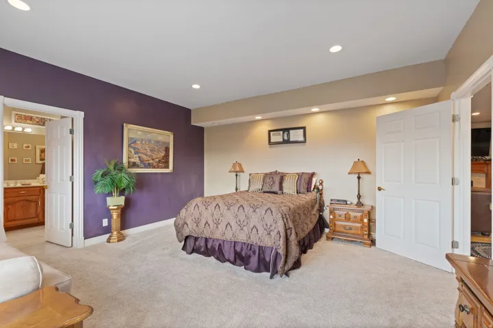Spacious primary bedroom with oversized windows for ample natural lighting