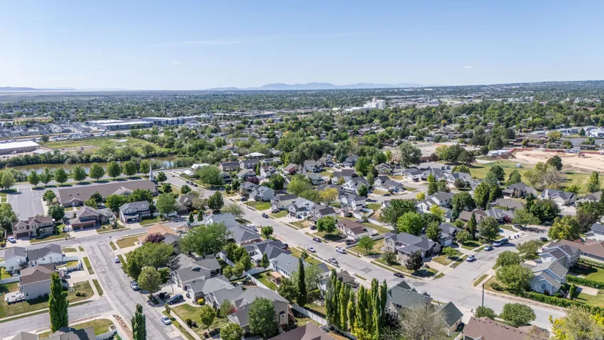 Aerial perspective showcasing a residential neighborhood with a variety of single-family homes and mature trees