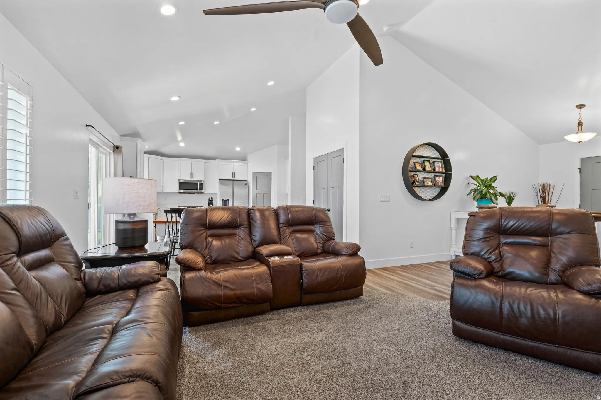 Living area featuring vaulted ceilings, recessed lighting, and a ceiling fan